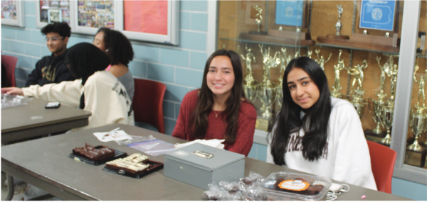 Donating for a cause: Juniors Lexi Patterson (left) and Mukti Patel (right) run a bake sale for a fundraiser for Morgan’s Message Campaign Club. Proceeds went toward a nonprofit that works to ensure that student athletes treat their mental and physical health equally.